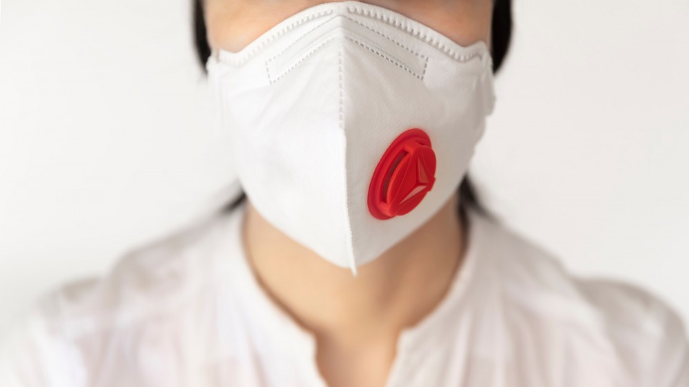 Woman wearing an N95 filtration mask with a valve.