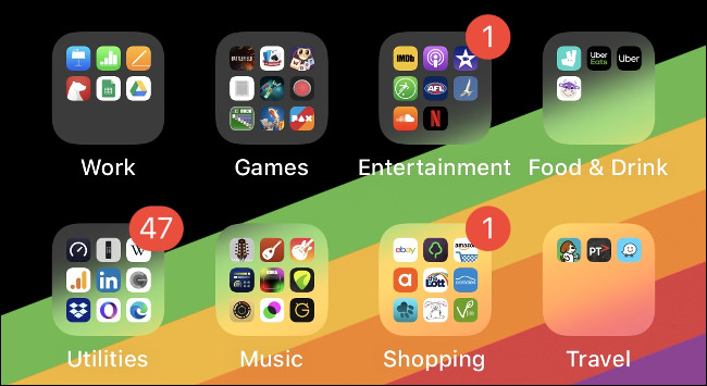 Folders of apps on an iOS Home screen organized by type.