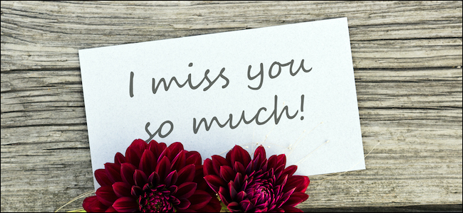 "I miss you so much" written on a sign next to flowers