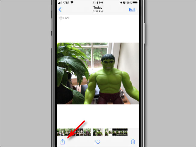 Tap the Share button in Photos on iPhone.