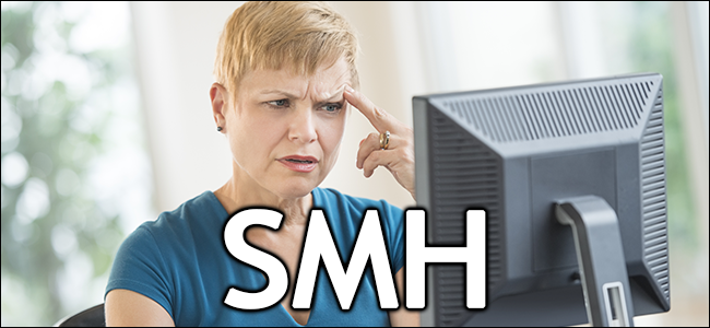 A woman looks confused at her computer.