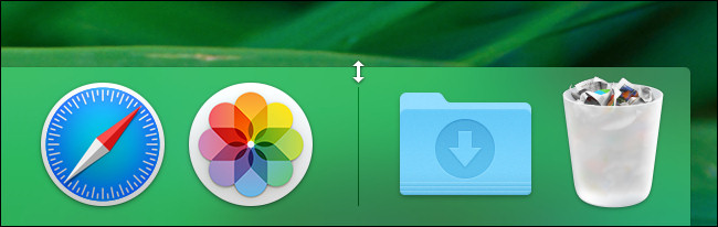 In macOS, hover your mouse pointer over the divider line in the Dock until it changes into a resize arrow.
